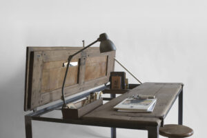 Indoor C shown with one door open as a writing desk, with a lamp and objects arranged on the wooden top