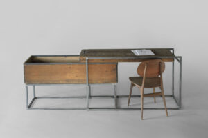 Sliding desk shown open with the lid functioning as a writing surface