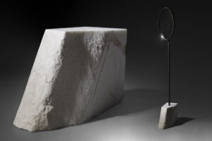 floor standing mirror with big white carrara marble base in dark studio view