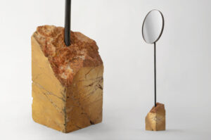 floor standing mirror with rosso verona marble base shown in studio setting
