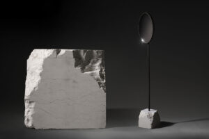 floor standing mirror with white perlino marble base in dark studio view