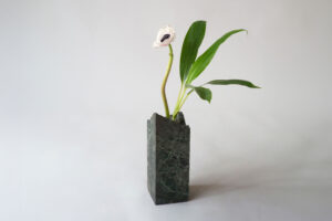 Green Alps marble sculpture vase with an irregular shape and one flower