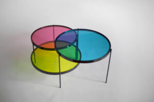 CMYK coffee table in diagram configuration with cyan magenta and yellow discs overlapping, generating violet orange and green