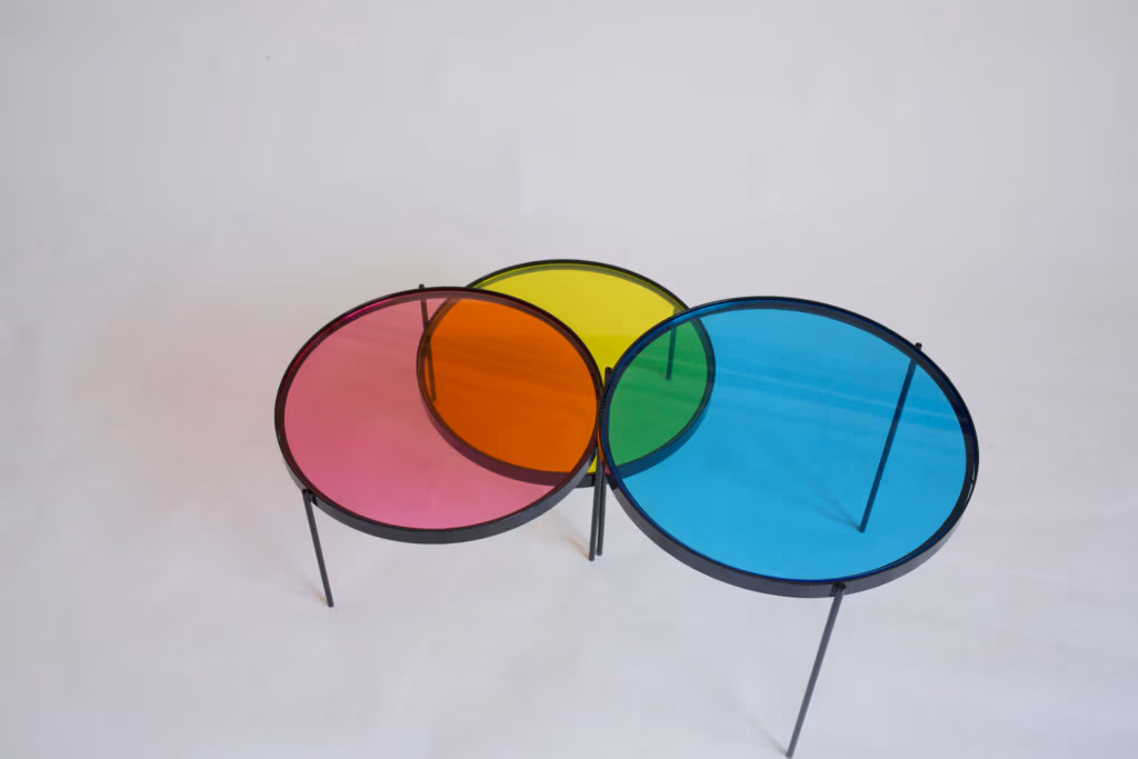 CMYK coffee table by Manoteca, rotation sequence 03: cyan disc moving further left, wider overlap with yellow disc, green intersection at medium extension, magenta and yellow discs stationary.